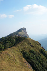 Natural landscape of green mountain range with cloudy blue sky