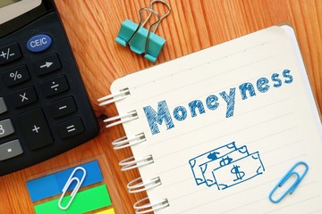 The photo shows Moneyness. Notepad, heap, marker.