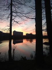 Wooden walk on the river at sunset in the town