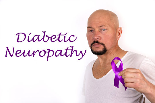 Diabetic Neuropathy Word, Medical Term Word With Medical Concepts On White Background. Purple Ribbon As A Sign Of Awareness In A Man S Hand.