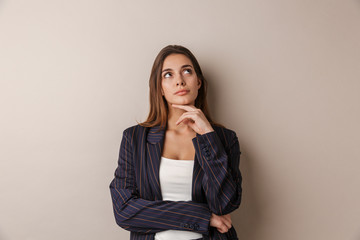 Photo of young businesswoman thinking and looking upward