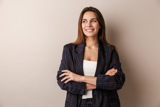 Photo of joyful businesswoman in formal suit laughing with arms crossed