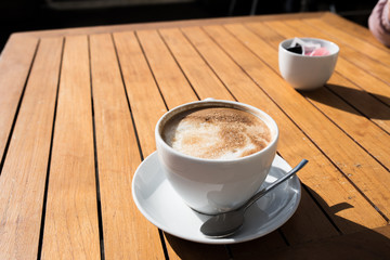 Cup of coffee on wooden table