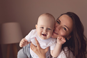 Portrait of a young mother and her one year old son at home.Casual lifestyle photo.