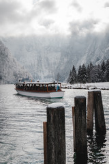 boat on the lake during winter surrounded by mountains