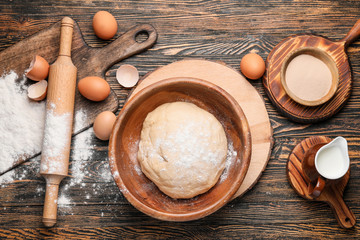 Fototapeta na wymiar Bowl with dough and ingredients on table