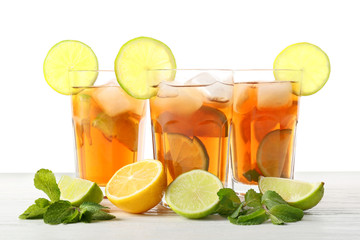 Glasses of tasty cold ice tea on white background