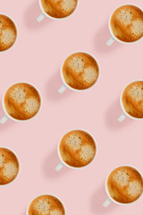 Pattern with a group of cups with coffee on a pink background.