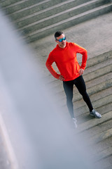 Aerial view of an handsome sportsman posing on the stairs.