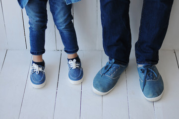 Close-up of father and little son feet in shoes.