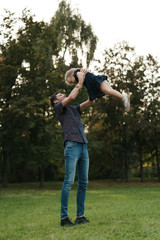 Happy dad and child spending time outdoors. Father daughter moments.