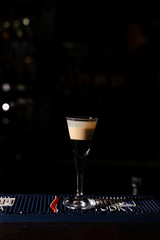  bartender sprinkles cinnamon on a burning cocktail