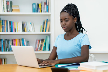 African american young adult female student at computer