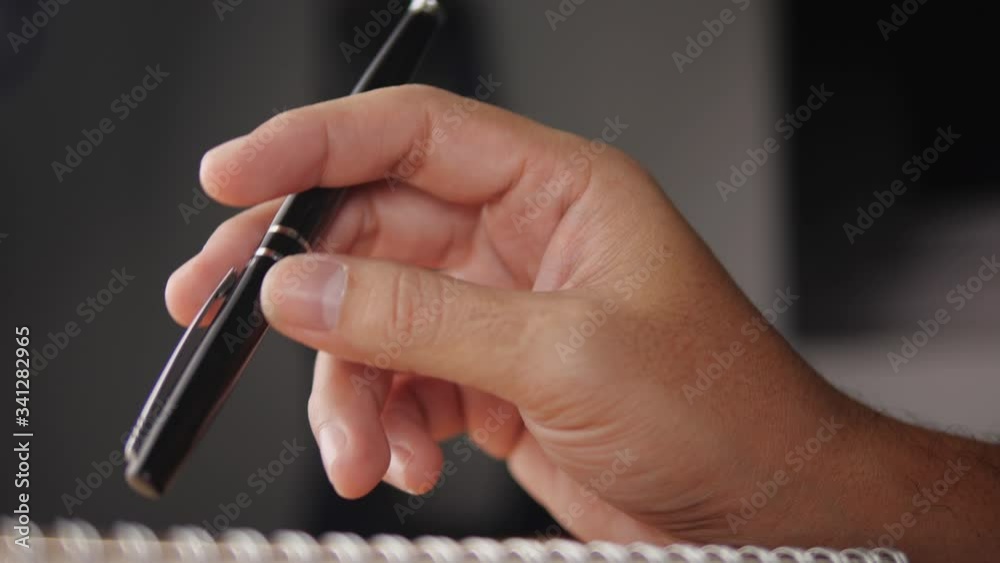 Poster businessman waiting for something and hand tapping with pen on the table