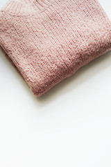 Flat lay of pink knitted sweater