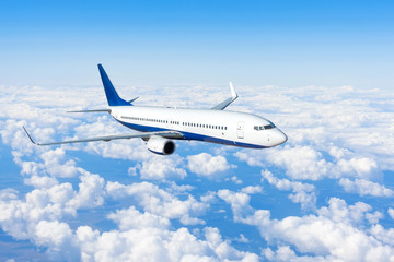 Flying a aircraft over fluffy cumulus clouds, aerial view.