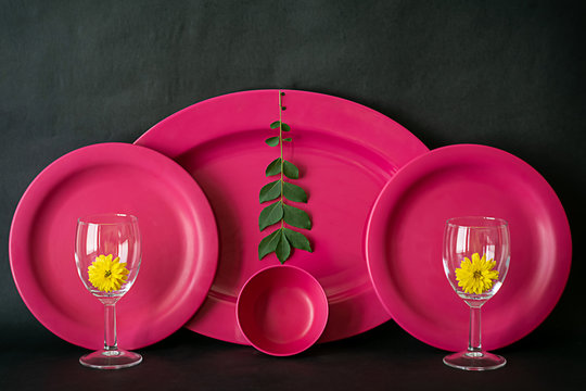 Abstract images of plates and glasses on black background. Images useful for  background, frames or indoor decors.