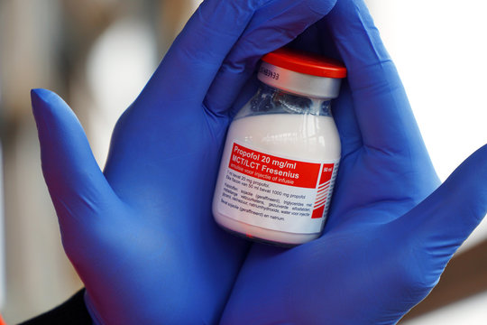 Arzt, Notarzt oder An&auml;sthesist mit Einweghandschuhen h&auml;lt eine Flasche mit Propofol als Narkotikum,  Narkosemittel oder Sedativum