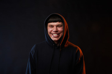 portrait young guy in white hoodie on medicine mask on black background