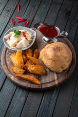 Traditional Georgian food. Meat loaf. Baked meat in pastry with potatoes and pickles.