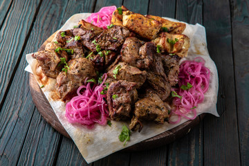 Assorted grilled meats: beef, pork, poultry, lamb. Juicy slices of meat delicacies. Food for a big company, a picnic.