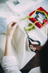 girl master scissors cuts the fabric. handmade. tailor
