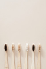 Bamboo toothbrushes on a beige background