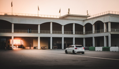 White offroader in the yard of an abandoned building