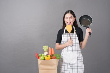 Happy woman is preparing healthy food to cooking