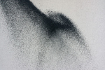 plaster surface of the exterior wall of the house is painted with black spray paint, traces of...