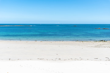 Empty blue sea and white sand beach background with copy space