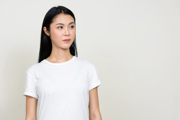 Portrait of young beautiful Asian woman thinking
