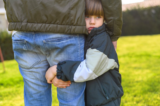 Close-up Kid Holding Adult's Leg