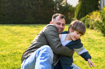 Kid and father playing on grass