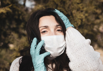 woman in a medical mask with a mobile phone