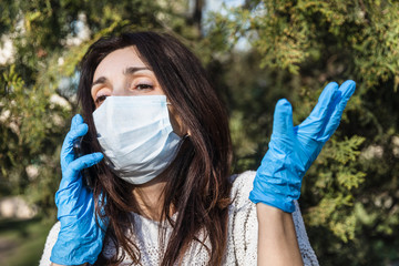 woman in a medical mask with a mobile phone