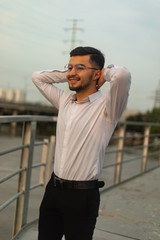 Man poses on an old bridge.