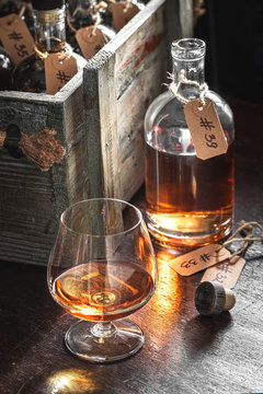 Aged Whisky On Wooden Box With Bottles From Distillery