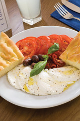 Tasty Lebanese food of Labneh Yogurt cheese with bread, tomato, and olives