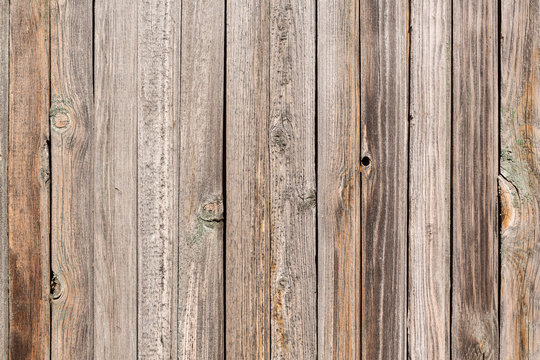 Vertical closeup of old wooden plank wall, brown wooden background, fence or floor panels