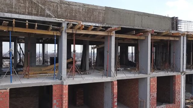 Construction site of a residential complex aerial view. Videography with a drone. Span over the construction site.