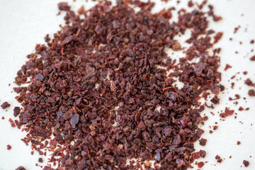 sumac powder on white wooden background