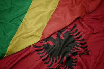 waving colorful flag of albania and national flag of republic of the congo.