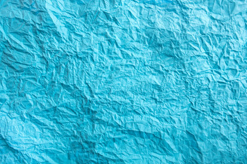 Blue crumpled paper background. Twisted blue paper. Seamless pattern.