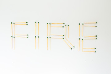 inscription fire from matches on a white background