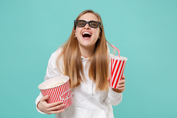 Laughing young woman in casual white hoodie, 3d glasses isolated on blue turquoise background....