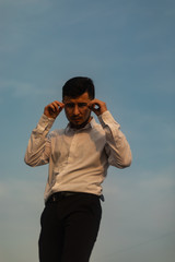 Man poses on an old bridge.