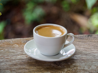 Hot coffee americano on the old wooden table