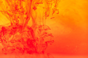 Plakat Close up red color ink Fluid liquid and smoke Abstract background. Color drop flowing in water.