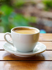Hot coffee americano on the old wooden table
